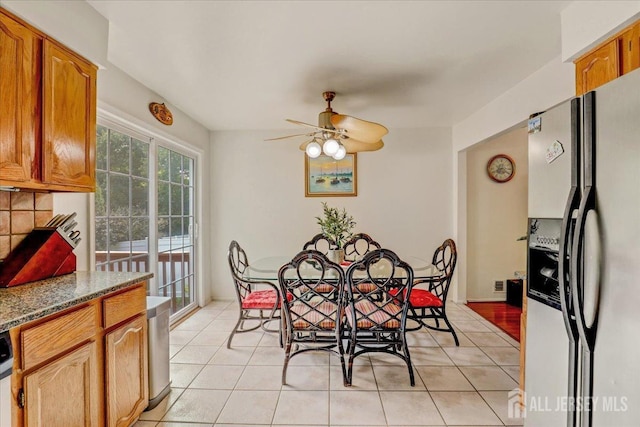 dining room with ceiling fan and light tile patterned flooring