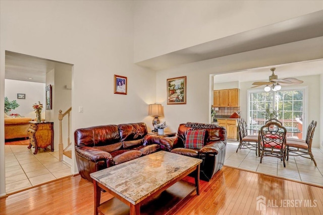 living room with light hardwood / wood-style floors and ceiling fan