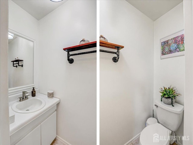 bathroom featuring vanity and toilet