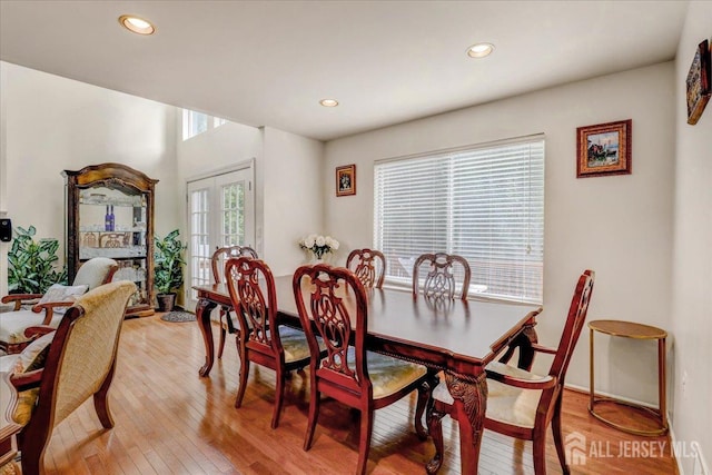 dining room featuring french doors and light hardwood / wood-style floors