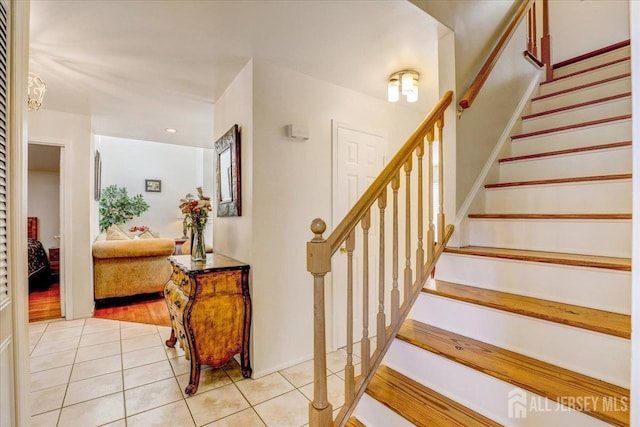 stairs featuring tile patterned flooring