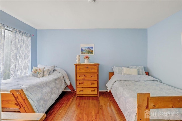 bedroom with hardwood / wood-style floors