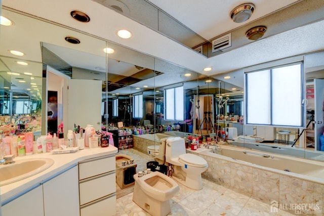 55 Smith St, Perth Amboy, NJ 08861 - bathroom with tiled bath, a bidet, and vanity
