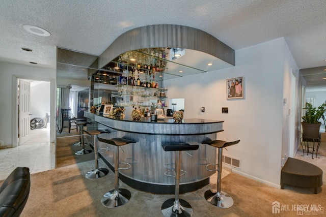 55 Smith St, Perth Amboy, NJ 08861 - indoor dry bar with carpet floors and a textured ceiling