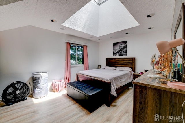 55 Smith St, Perth Amboy, NJ 08861 - bedroom featuring a textured ceiling, light wood-type flooring, a skylight, and recessed lighting