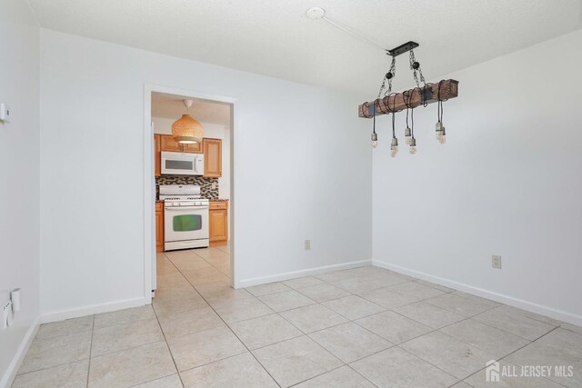 55 Smith St, Perth Amboy, NJ 08861 - unfurnished room with light tile patterned flooring and baseboards