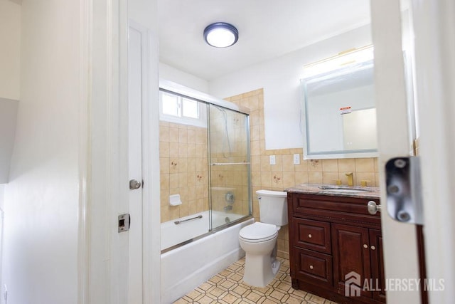 20 Wick Dr, Fords, NJ 08863 - full bathroom with tile walls, vanity, and combined bath / shower with glass door