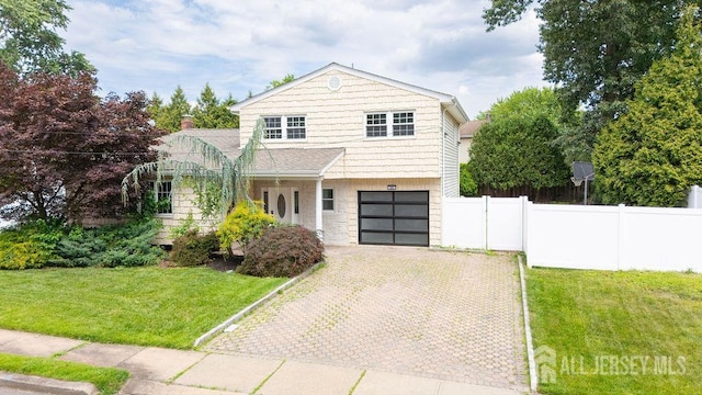 20 Wick Dr, Fords, NJ 08863 - view of front of home with decorative driveway, a garage, and stone siding