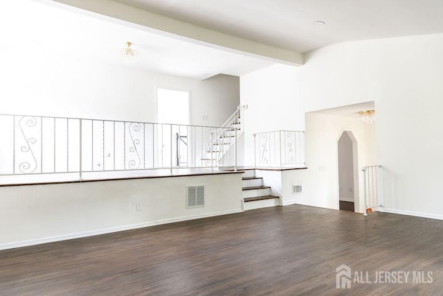 20 Wick Dr, Fords, NJ 08863 - unfurnished living room with wood finished floors, beam ceiling, stairs, and arched walkways