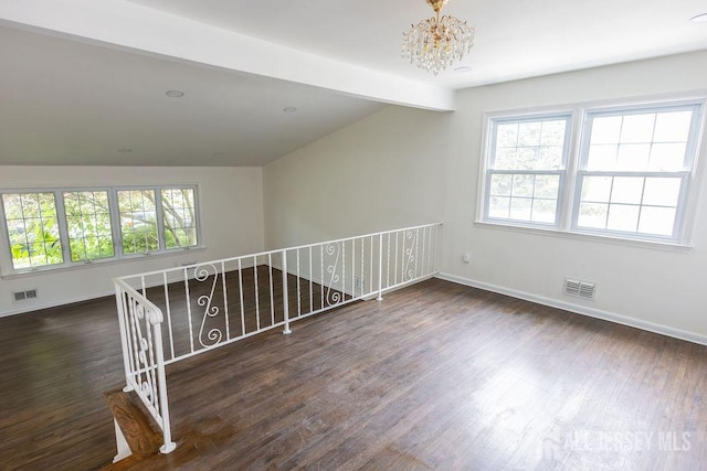 20 Wick Dr, Fords, NJ 08863 - empty room with a chandelier, plenty of natural light, wood finished floors, and vaulted ceiling