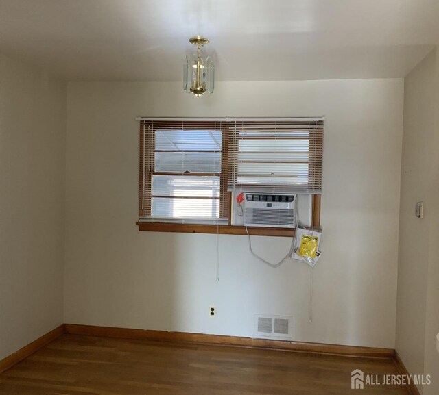 unfurnished room with wood-type flooring and cooling unit