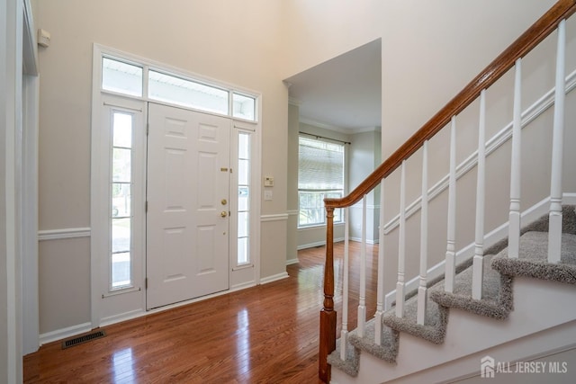 23 Heather Ct, Plainsboro, NJ 08536 - entrance foyer with stairway, wood finished floors, plenty of natural light, ornamental molding, and baseboards