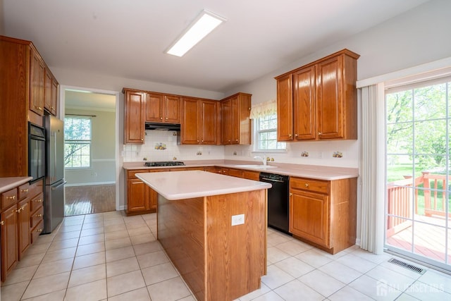 23 Heather Ct, Plainsboro, NJ 08536 - kitchen featuring black appliances, a sink, light countertops, a center island, and under cabinet range hood