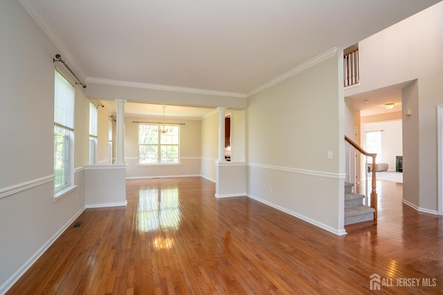 23 Heather Ct, Plainsboro, NJ 08536 - spare room featuring decorative columns, wood finished floors, a chandelier, baseboards, and ornamental molding