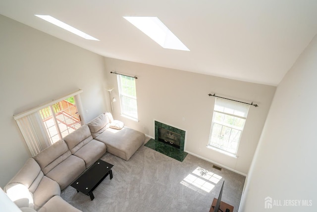 23 Heather Ct, Plainsboro, NJ 08536 - carpeted living area featuring a skylight, vaulted ceiling, and a fireplace with flush hearth