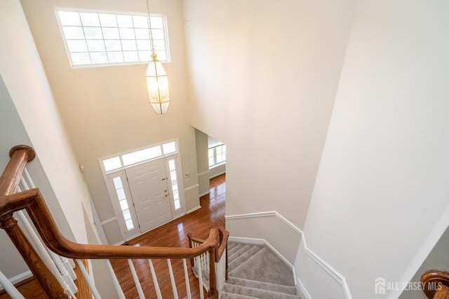23 Heather Ct, Plainsboro, NJ 08536 - stairway featuring baseboards, wood finished floors, and a high ceiling