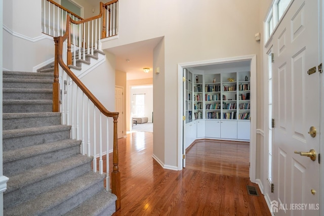 23 Heather Ct, Plainsboro, NJ 08536 - foyer entrance with a high ceiling, wood finished floors, stairs, and baseboards