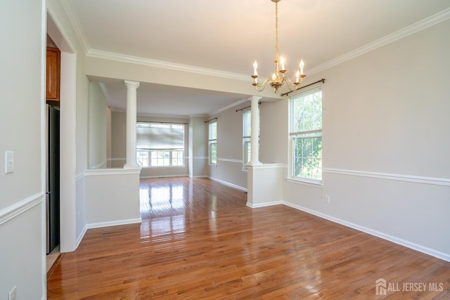 23 Heather Ct, Plainsboro, NJ 08536 - spare room with ornate columns, plenty of natural light, ornamental molding, and light wood-style floors