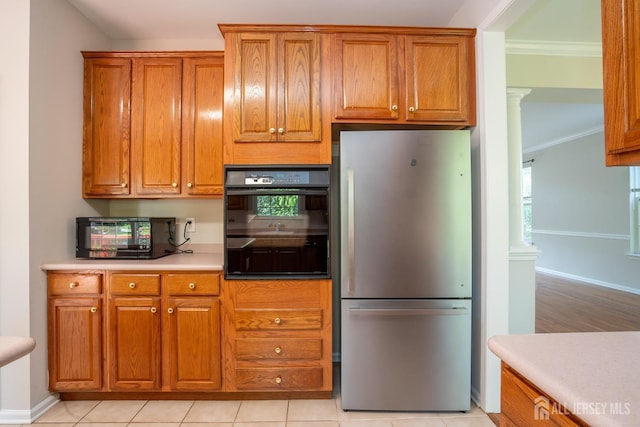 23 Heather Ct, Plainsboro, NJ 08536 - kitchen with freestanding refrigerator, black oven, crown molding, brown cabinetry, and light countertops