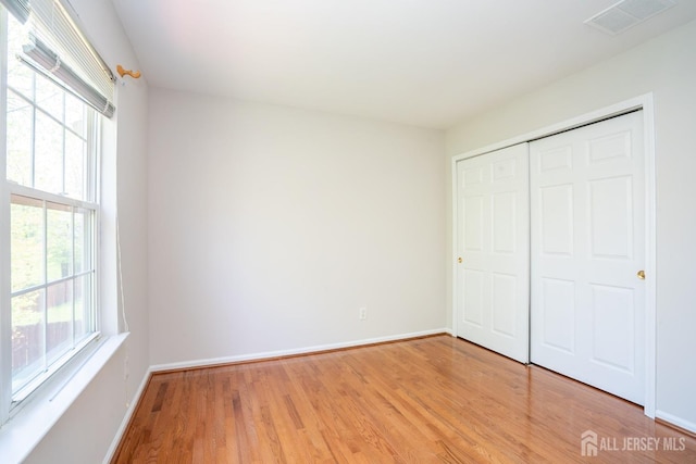 23 Heather Ct, Plainsboro, NJ 08536 - unfurnished bedroom with light wood-style flooring, baseboards, and a closet