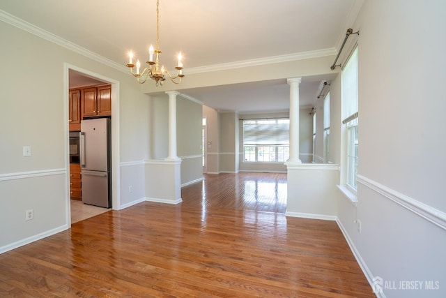 23 Heather Ct, Plainsboro, NJ 08536 - unfurnished dining area featuring ornate columns, ornamental molding, light wood finished floors, baseboards, and a chandelier