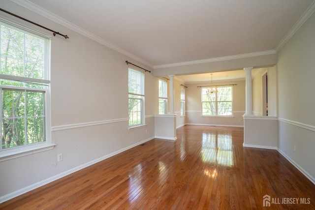 23 Heather Ct, Plainsboro, NJ 08536 - spare room with ornate columns, a chandelier, wood-type flooring, baseboards, and crown molding