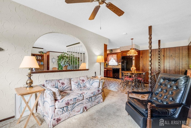 92 Maplewood Ave, Edison, NJ 08837 - living room featuring a textured ceiling, a textured wall, a ceiling fan, light colored carpet, and arched walkways
