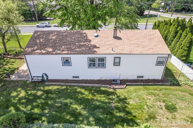 92 Maplewood Ave, Edison, NJ 08837 - rear view of house with a shingled roof, a lawn, and a chimney