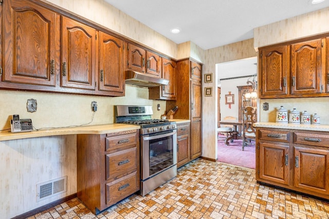 92 Maplewood Ave, Edison, NJ 08837 - kitchen featuring stainless steel range with gas stovetop, under cabinet range hood, light countertops, and brown cabinetry