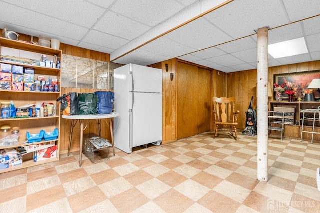 92 Maplewood Ave, Edison, NJ 08837 - finished basement featuring freestanding refrigerator, tile patterned floors, a paneled ceiling, and wooden walls
