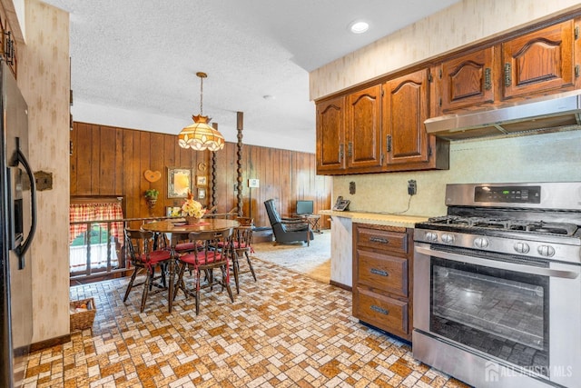 92 Maplewood Ave, Edison, NJ 08837 - kitchen with appliances with stainless steel finishes, under cabinet range hood, wood walls, light countertops, and brown cabinetry