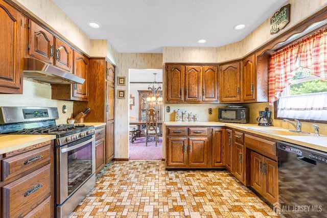 92 Maplewood Ave, Edison, NJ 08837 - kitchen with black appliances, under cabinet range hood, light countertops, brown cabinetry, and recessed lighting