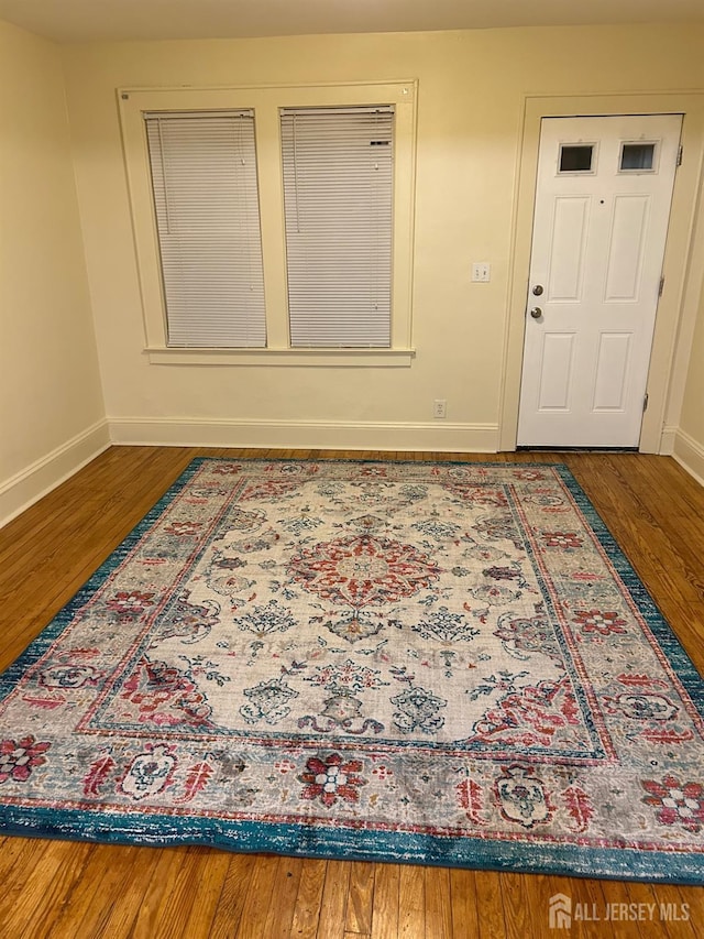 interior space featuring wood finished floors and baseboards