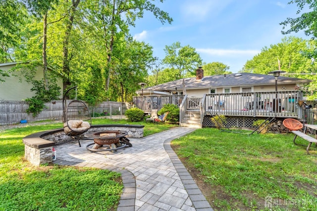 430 Wood Ave, North Brunswick, NJ 08902 - fenced backyard with a fire pit, a patio, and a wooden deck