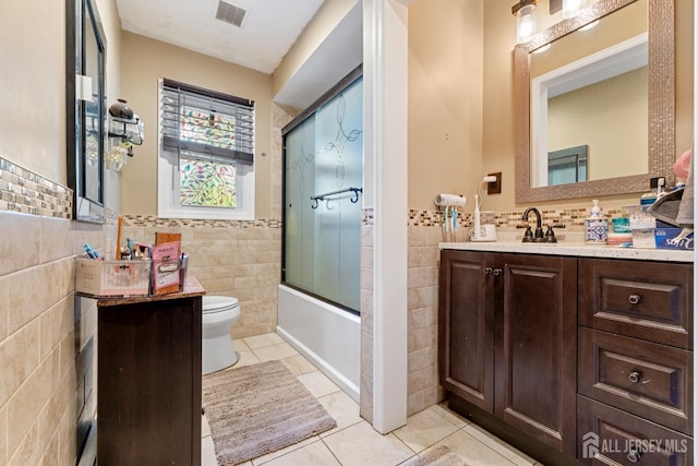 430 Wood Ave, North Brunswick, NJ 08902 - full bath featuring tile walls, tile patterned floors, vanity, enclosed tub / shower combo, and wainscoting