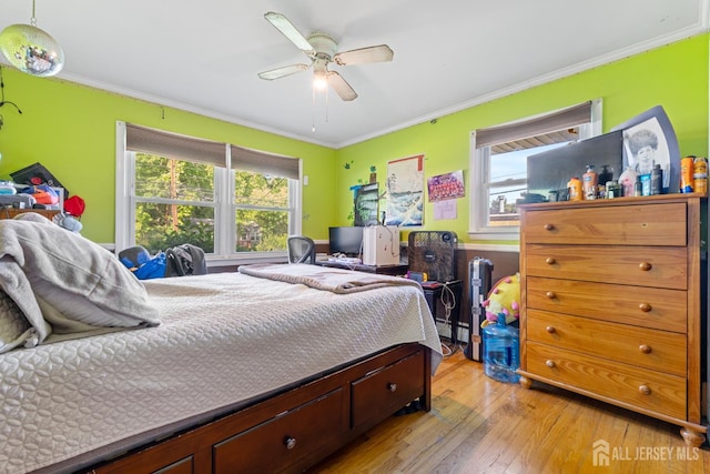 430 Wood Ave, North Brunswick, NJ 08902 - bedroom with light wood-style floors, ornamental molding, ceiling fan, and baseboard heating