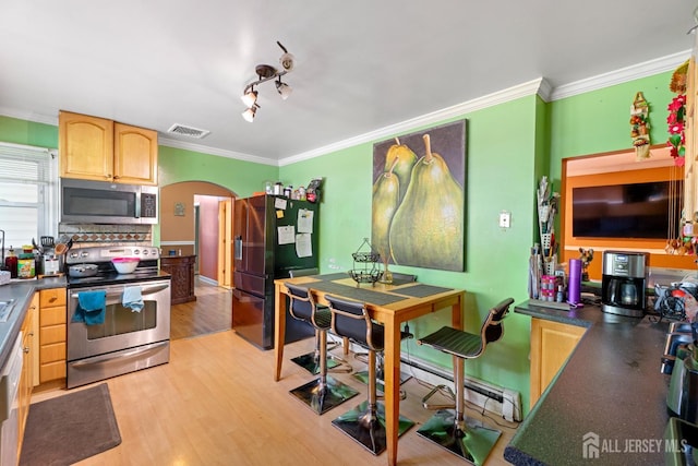 430 Wood Ave, North Brunswick, NJ 08902 - kitchen with stainless steel appliances, arched walkways, ornamental molding, light brown cabinets, and dark countertops
