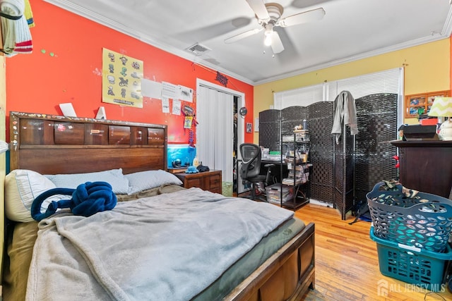 430 Wood Ave, North Brunswick, NJ 08902 - bedroom featuring ornamental molding, wood-type flooring, a closet, and a ceiling fan