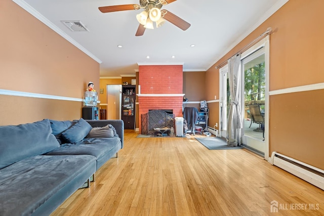 430 Wood Ave, North Brunswick, NJ 08902 - living room featuring a baseboard heating unit, wood finished floors, a ceiling fan, crown molding, and a brick fireplace