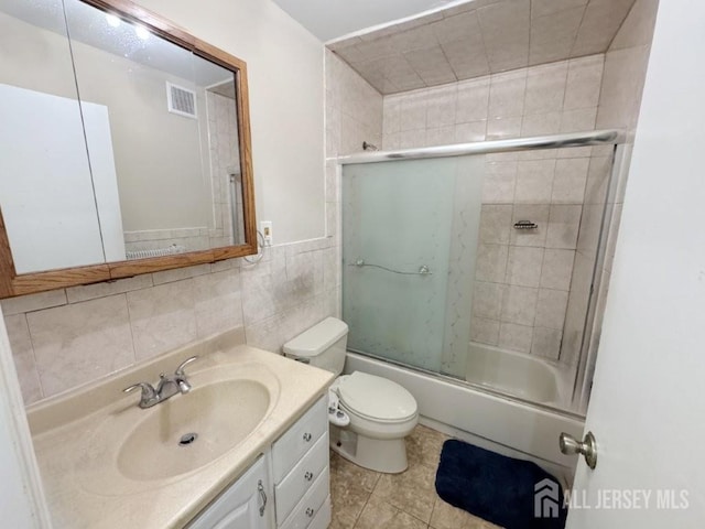 92 Beverly Hill Ter Unit D, Woodbridge Proper, NJ 07095 - bathroom featuring vanity, shower / bath combination with glass door, tile walls, and tile patterned floors