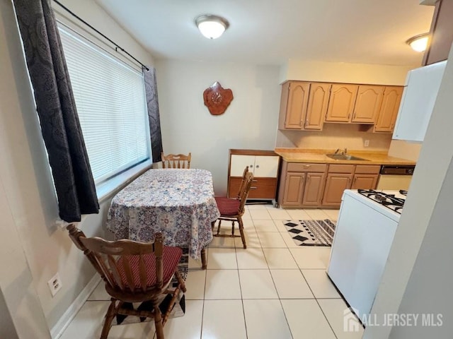 92 Beverly Hill Ter Unit D, Woodbridge Proper, NJ 07095 - kitchen with white range with gas stovetop, light brown cabinetry, light countertops, and light tile patterned floors