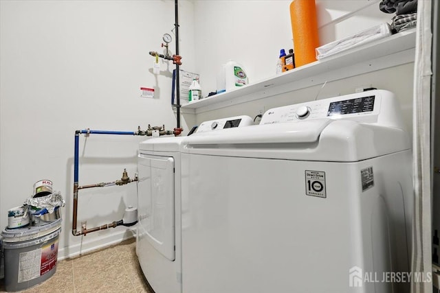 washroom with separate washer and dryer, tile patterned flooring, and laundry area