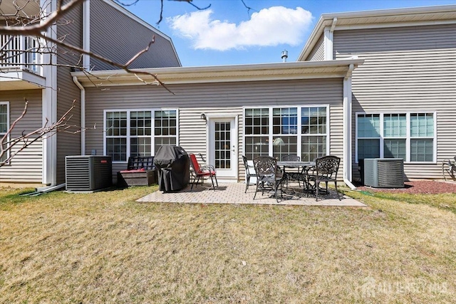 back of property featuring a patio area, a lawn, and central air condition unit