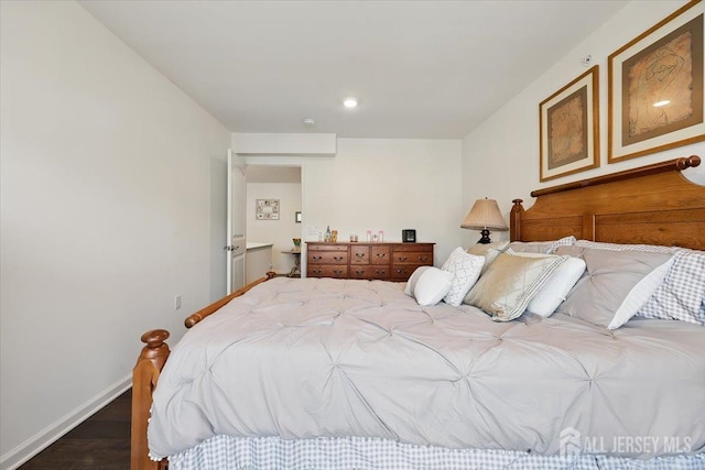 bedroom with baseboards and wood finished floors
