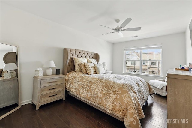 bedroom with dark wood-style flooring, a ceiling fan, and visible vents