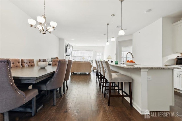 dining room featuring a chandelier and dark wood-style floors