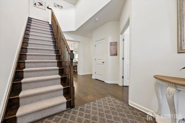 stairs featuring baseboards and wood finished floors