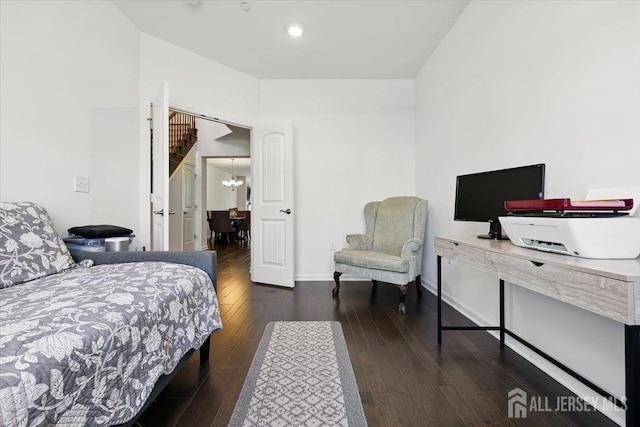 bedroom featuring wood-type flooring, baseboards, a notable chandelier, and recessed lighting