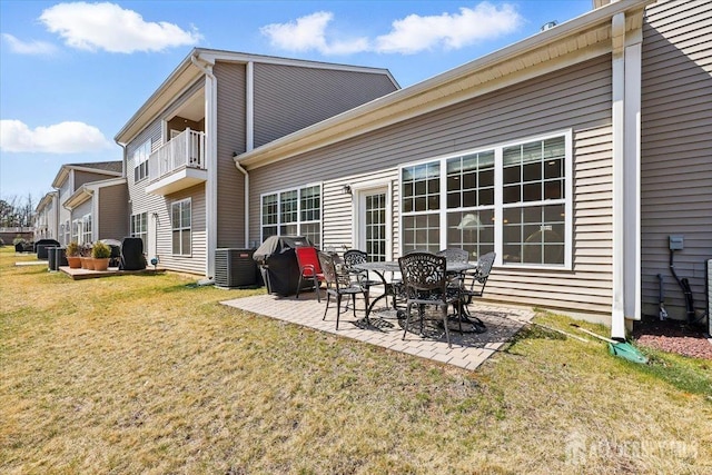 rear view of house featuring a yard, a patio area, and central AC
