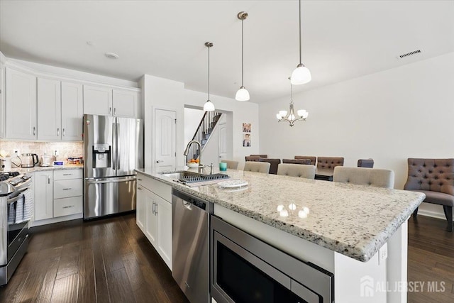 kitchen featuring white cabinets, visible vents, a sink, and appliances with stainless steel finishes